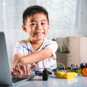Asian-kid-boy-learns-coding-and-programming-happily